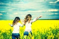 Pretty girls running in the field in embroidery shirts Royalty Free Stock Photo