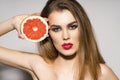 Pretty Glamour girl holding grapefruit Royalty Free Stock Photo