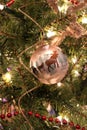 Pretty gold-colored holiday ribbons and handmade decorations adorn a Christmas tree