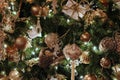 Pretty gold and silver holiday ornaments hanging from branches of Christmas tree Royalty Free Stock Photo