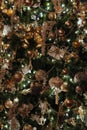 Pretty gold and silver holiday ornaments hanging from branches of Christmas tree Royalty Free Stock Photo