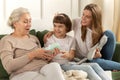 Grandma recieve present from granddaughter Royalty Free Stock Photo