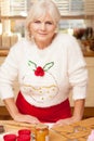 Pretty grandmother in kitchen, christmas time.