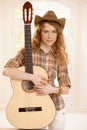 Pretty guitarplayer girl embracing guitar Royalty Free Stock Photo