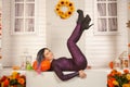 Pretty halloween woman in tight tiger jumpsuit ready to celebrate and waiting for friends for a party outdoor