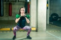 Pretty and handsome young girl holding two kettle bells in her hands for strength and conditioning fitness workout in the gym, spo Royalty Free Stock Photo