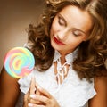 Curly girl with a lollipop in her hand Royalty Free Stock Photo