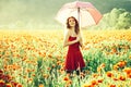 Pretty happy girl in field of poppy seed with umbrella Royalty Free Stock Photo