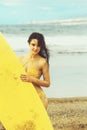 Pretty happy girl surfer with yellow surfboard Royalty Free Stock Photo