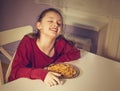 Pretty happy laughing kid girl eating tasty spaghetti on the dinner on the home kitchen. Closeup Royalty Free Stock Photo