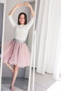 Pretty happy tween girl dancing like ballerina looking at mirror at home. Royalty Free Stock Photo