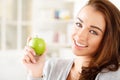 Pretty healthy young woman smiling holding a green apple Royalty Free Stock Photo