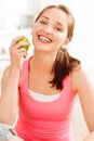 Pretty healthy young woman smiling holding a green apple Royalty Free Stock Photo