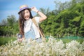 Pretty hipster asian teen girl in a spring white flower garden, Royalty Free Stock Photo