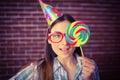 Pretty hipster with party hat and lollipop Royalty Free Stock Photo