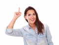 Pretty hispanic lady pointing up and smiling Royalty Free Stock Photo