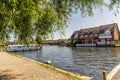 Waterfront holiday properties on the bank of the River Bure in the village of Hoveton and Wroxham, Norfolk, UK