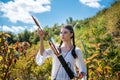 hunter girl shooting bow and arrow in the grassland Royalty Free Stock Photo