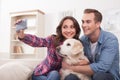 Pretty husband and wife with cute puppy Royalty Free Stock Photo