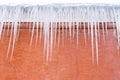 Pretty icicles on brick wall background Royalty Free Stock Photo