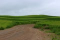 Gorgeous landscape with dirt path running through farmland in the rural countryside Royalty Free Stock Photo