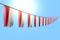 pretty independence day flag 3d illustration - many Poland flags or banners hangs diagonal on rope on blue sky background with