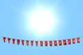 pretty independence day flag 3d illustration - many Vietnam flags or banners hanging on rope on blue sky background