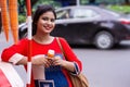 Pretty Indian/Asian young girl eating Ice Cream in cone, standing near taxi or ice cream shop Royalty Free Stock Photo