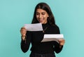 Indian woman open envelope letter great news celebrate monetary award, invitation, bank loan approve