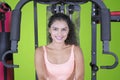 Pretty Indian woman sits on a fitness machine