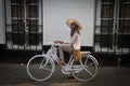 Pretty Indonesian woman in a hat and bike, Jakarta, Indonesia