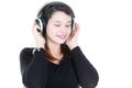 Pretty inspired young woman listening headphones earphones music with eyes closed Royalty Free Stock Photo