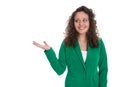 Pretty isolated business woman in green presenting with hand.