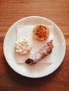 Pretty Italian pastries (including cannoli) on a plate