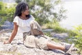 Pretty ivorian girl posing on the bank of a river Royalty Free Stock Photo