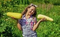 pretty kid on farm. beauty of summer nature. little girl on farming garden with squash. growing vegetable marrow. happy Royalty Free Stock Photo