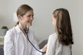 Pretty kid girl visiting pediatrician for medical checkup