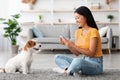 Pretty korean lady taking photo of jack russel terrier Royalty Free Stock Photo