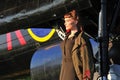 Pretty lady in army uniform with WWII bomber