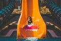 Lady going down by the slide in aqua park Royalty Free Stock Photo