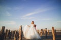 Pretty lady, bride posing in a wedding dress near sea on sunset Royalty Free Stock Photo