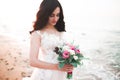 Pretty lady, bride posing in a wedding dress near sea on sunset Royalty Free Stock Photo