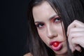 Pretty lady with fleshy lips, sucking a sweet cherry