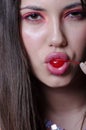 Pretty lady with fleshy lips, sucking a sweet cherry Royalty Free Stock Photo