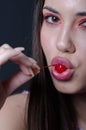 Pretty lady with fleshy lips, sucking a sweet cherry Royalty Free Stock Photo