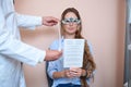 Pretty lady getting qualified checking her visual acuity in the medical office Royalty Free Stock Photo