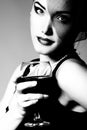 Pretty lady inhat with veil holding glass of wine, retro glamour beauty portrait. Beautiful woman with perfect makeup