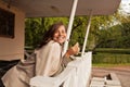 Pretty lady outdoor. Happy woman holding flower and smiling outdoors Royalty Free Stock Photo