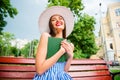 Pretty lady reading romance story overjoyed by final sitting cozy brunch wear sun hat and dress