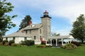 Sodus Point Lighthouse, brilliant green lawns and flower gardens under sunny skies, Sodus Point New York, summer, 2022